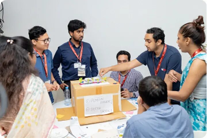 Young participants work together around a table at FIF